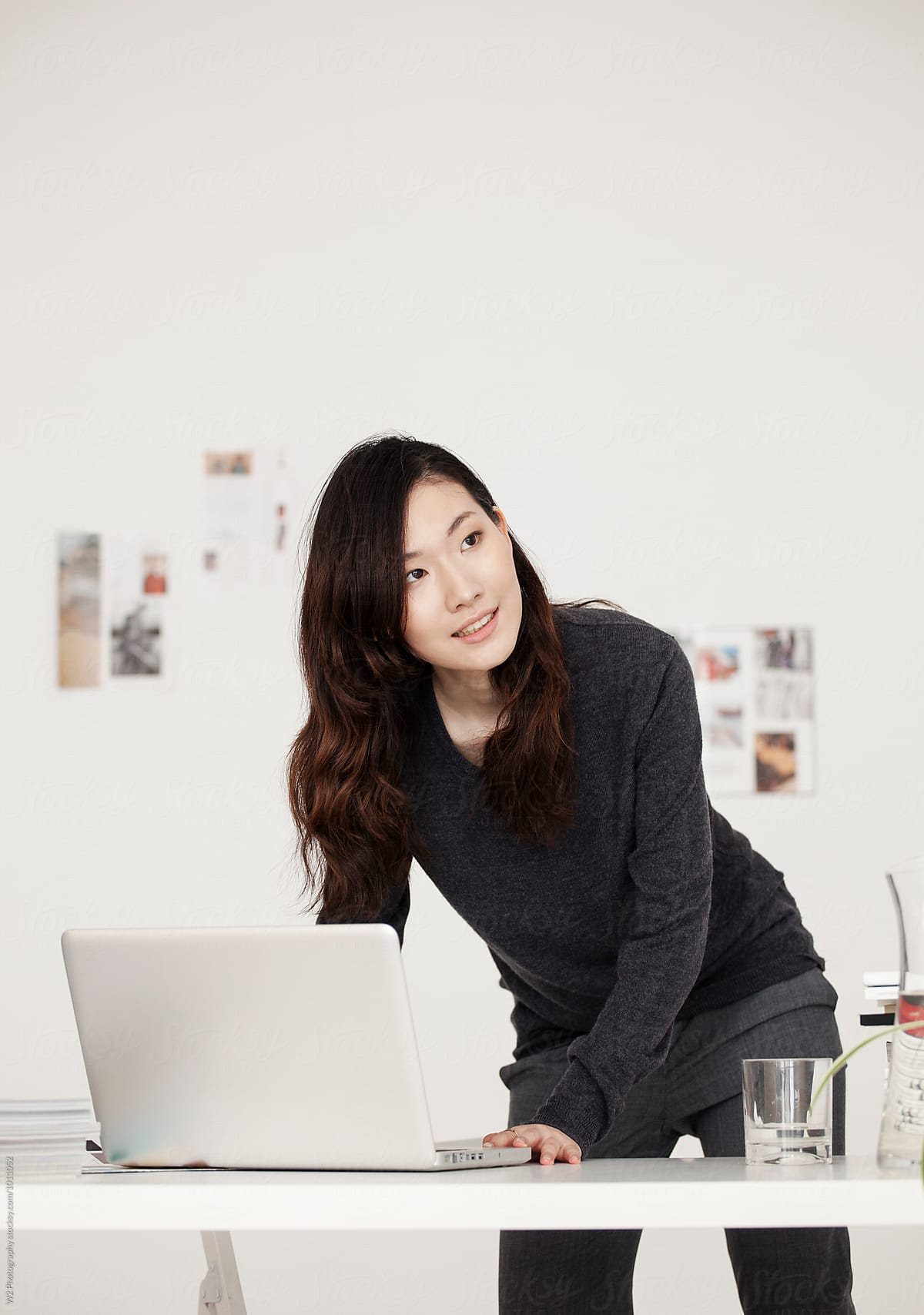 Professional Indonesian woman working in a modern corporate office environment